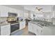 Modern kitchen with stainless steel appliances, white cabinets and view to the dining area at 469 Hainsworth Dr, Charleston, SC 29414