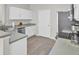 Well-lit kitchen showcasing white cabinets, stainless steel sink, and appliances at 469 Hainsworth Dr, Charleston, SC 29414