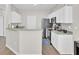 Bright kitchen features white cabinets, stainless appliances, and bar seating area at 469 Hainsworth Dr, Charleston, SC 29414
