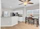 An eat-in kitchen features a dining table next to an open view of white cabinets and stainless appliances at 469 Hainsworth Dr, Charleston, SC 29414