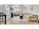 Bright living room featuring wood flooring, fireplace, ceiling fan, and comfortable seating at 469 Hainsworth Dr, Charleston, SC 29414