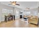 Open-concept living room with fireplace, ceiling fan, and modern furniture at 469 Hainsworth Dr, Charleston, SC 29414