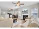 Open living room boasts a fireplace, tv, ceiling fan, and adjoins kitchen and dining areas at 469 Hainsworth Dr, Charleston, SC 29414