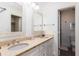Well-lit bathroom with double vanity, framed mirrors, and tiled floors at 509 Summerhouse, Isle of Palms, SC 29451