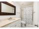 Bathroom features a vanity with a framed mirror and shower with polka dot curtain at 509 Summerhouse, Isle of Palms, SC 29451