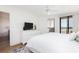Comfortable bedroom with white dresser, TV, and balcony access offering partial ocean views at 509 Summerhouse, Isle of Palms, SC 29451