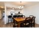 Open-concept dining area with a breakfast bar, modern lighting, and wood flooring at 509 Summerhouse, Isle of Palms, SC 29451