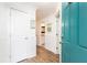 Bright hallway featuring white wainscoting, wood floors, and a glimpse into the bathroom at 509 Summerhouse, Isle of Palms, SC 29451