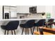 Eat-in kitchen featuring stainless appliances, breakfast bar with seating, and wood flooring at 509 Summerhouse, Isle of Palms, SC 29451