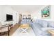 Bright living room with comfortable seating, light wood floors, and stylish coastal decor at 509 Summerhouse, Isle of Palms, SC 29451