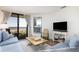 Cozy living room with ocean views through sliding glass doors to a private balcony at 509 Summerhouse, Isle of Palms, SC 29451