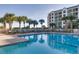 Inviting outdoor pool with palm trees and lounge seating offers a relaxing retreat at 509 Summerhouse, Isle of Palms, SC 29451