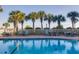 Relaxing pool area with chairs and lush palm trees at 509 Summerhouse, Isle of Palms, SC 29451