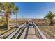 A wooden walkway leads to the beach at 509 Summerhouse, Isle of Palms, SC 29451