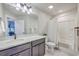 Well-lit bathroom featuring a vanity with a granite countertop, a shower with a curtain, and a mirrored cabinet at 5135 Park Creek Ave, North Charleston, SC 29418
