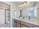 Well-lit bathroom with a double sink vanity, modern fixtures, a large mirror, and glass enclosed shower at 5135 Park Creek Ave, North Charleston, SC 29418