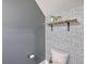 Stylish bathroom featuring decorative wallpaper, a wooden shelf with plants, and modern fixtures at 5135 Park Creek Ave, North Charleston, SC 29418