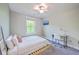 Bright bedroom with a large window, ceiling fan, wall-mounted television and a comfortable bed with plenty of pillows at 5135 Park Creek Ave, North Charleston, SC 29418