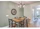 Dining room with a wooden table, seating for four, elegant chandelier, and stylish decor at 5135 Park Creek Ave, North Charleston, SC 29418