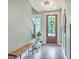 Inviting foyer with a wooden bench, decorative mirror, and a stylish front door with natural light at 5135 Park Creek Ave, North Charleston, SC 29418