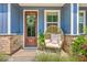 Inviting front porch with a comfortable chair and stylish decor, perfect for relaxing and enjoying the outdoors at 5135 Park Creek Ave, North Charleston, SC 29418