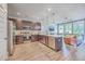 Open-concept kitchen with stainless steel appliances, dark wood cabinets, and a large island counter with bar stool seating at 5135 Park Creek Ave, North Charleston, SC 29418