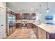 Well-lit kitchen featuring stainless steel appliances, dark wood cabinets, and a spacious quartz countertop at 5135 Park Creek Ave, North Charleston, SC 29418