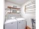 Practical laundry room with modern washer and dryer, shelving, and storage solutions at 5135 Park Creek Ave, North Charleston, SC 29418