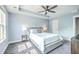Cozy main bedroom with a tray ceiling, ceiling fan, carpet and soft blue walls bathed in natural light at 5135 Park Creek Ave, North Charleston, SC 29418