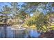 Scenic pond with fountain surrounded by lush greenery and community homes at 5135 Park Creek Ave, North Charleston, SC 29418