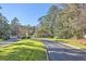 Beautiful community street with lush lawns and landscaped entry at 5135 Park Creek Ave, North Charleston, SC 29418