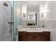 Bright bathroom featuring marble tile, glass shower, and elegant fixtures in a classic design at 6002 Green Dolphin Way, Kiawah Island, SC 29455