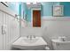 Bathroom with a white sink, mirror, decor, toilet, and stylish fixtures and wainscotting at 6002 Green Dolphin Way, Kiawah Island, SC 29455