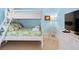 Bright bedroom with a white bunk bed, side table, artwork, silver chair and a dresser at 6002 Green Dolphin Way, Kiawah Island, SC 29455