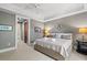 Relax in this bedroom featuring a king bed, sitting area, and ensuite bathroom with marble tile at 6002 Green Dolphin Way, Kiawah Island, SC 29455