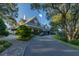 Grand estate exterior with a circular drive, manicured landscaping, and classic architectural details at 6002 Green Dolphin Way, Kiawah Island, SC 29455