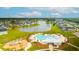 Beautiful aerial view showcasing a community pool, lake, and surrounding residential area at 627 Macintyre Cir, Summerville, SC 29486
