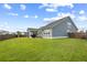 Spacious backyard with green grass, a screened-in porch, and a fenced perimeter at 627 Macintyre Cir, Summerville, SC 29486