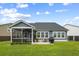 Well-manicured backyard with a patio, grill, and screened-in porch for outdoor enjoyment at 627 Macintyre Cir, Summerville, SC 29486