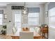 Cozy dining area with modern light fixture, comfortable seating, and a view of the backyard at 627 Macintyre Cir, Summerville, SC 29486