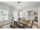 Bright dining room with modern chandelier, stylish buffet, and large windows for natural light at 627 Macintyre Cir, Summerville, SC 29486