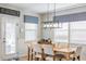 Light and airy dining room features a wooden table with seating for six and wainscotting at 627 Macintyre Cir, Summerville, SC 29486