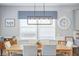 Bright dining room features a wooden table with seating for six, neutral gray walls, and modern decor at 627 Macintyre Cir, Summerville, SC 29486