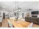 Open floor plan with dining room with wooden table and seating for six flowing into the kitchen and living room at 627 Macintyre Cir, Summerville, SC 29486