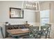 Bright dining room with modern chandelier, stylish buffet, and large windows for natural light at 627 Macintyre Cir, Summerville, SC 29486
