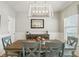 Bright dining room with modern chandelier, stylish buffet, and large windows for natural light at 627 Macintyre Cir, Summerville, SC 29486