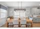Bright dining room features a wooden table with seating for six, neutral gray walls, and modern decor at 627 Macintyre Cir, Summerville, SC 29486