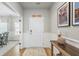 Inviting foyer with wood floors, elegant wainscoting, a console table, and access to dining and living areas at 627 Macintyre Cir, Summerville, SC 29486