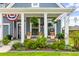 Relaxing front porch with rocking chairs, lush plants and patriotic decor to welcome you home at 627 Macintyre Cir, Summerville, SC 29486