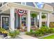 Relaxing front porch with rocking chairs, lush plants and patriotic decor to welcome you home at 627 Macintyre Cir, Summerville, SC 29486